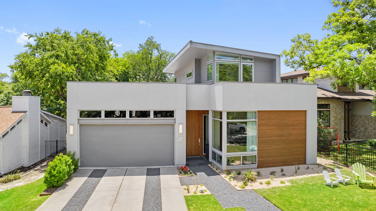 Front elevation of the Mark Dawson Homes built contemporary residence at 34 Margranita Crescent in Tarrytown, Austin, TX, with a two story massing and attached garage.