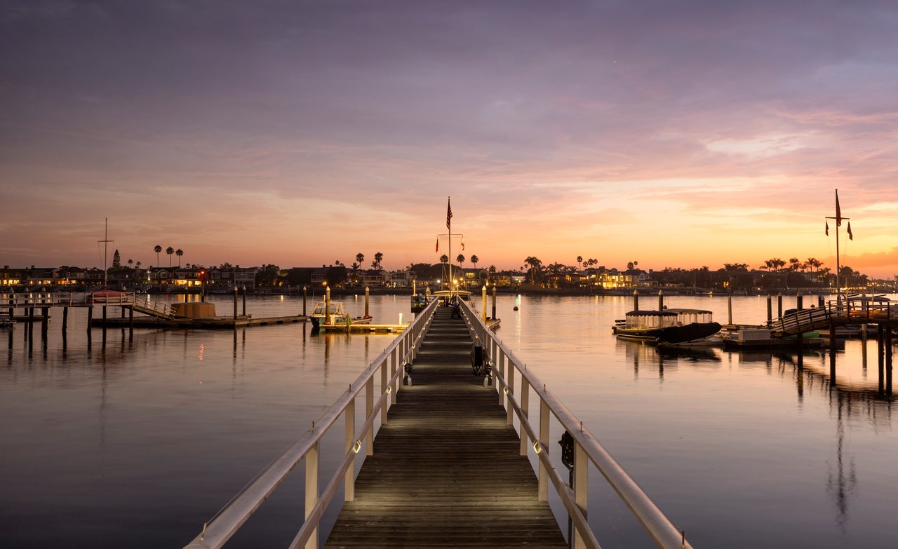 sun setting over harbor and pier