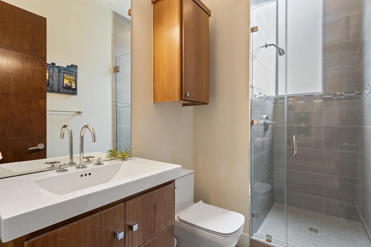 Secondary bathroom with a wood vanity at 34 Margranita Crescent, Tarrytown, Austin, TX.