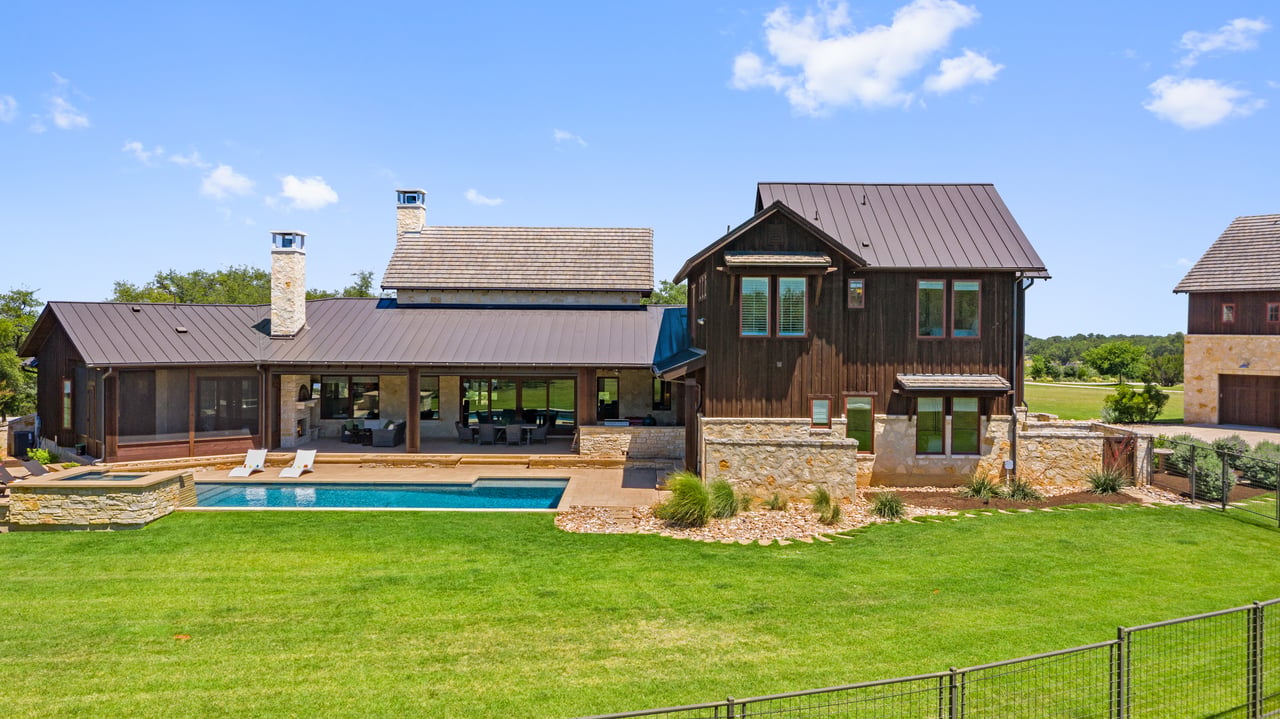 Screened porch and pool at 335 Winning Colors with a hill country elevation in the background.