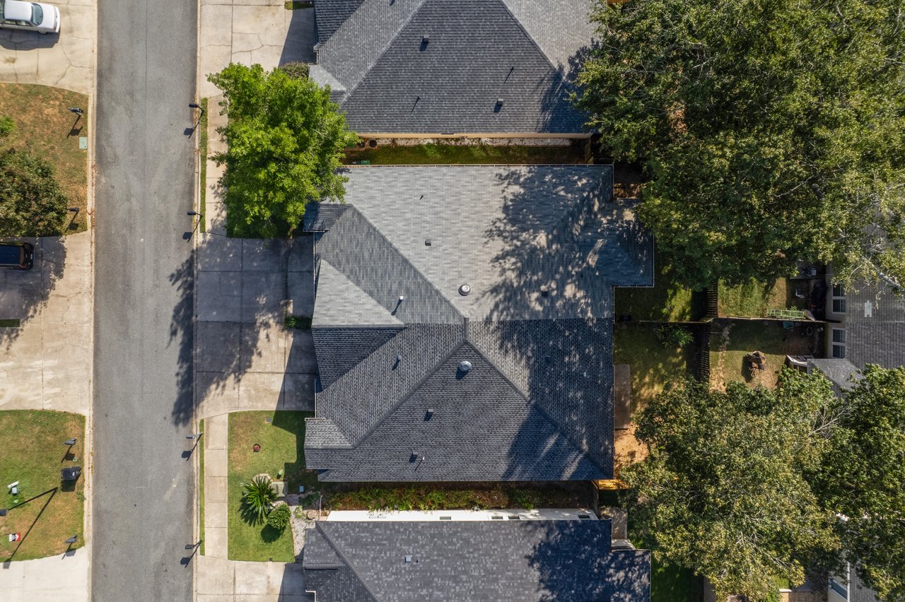 Overhead aerial view of 5441 Hampton Hill Circle, Tallahassee, Florida 32311 showing roof layout, driveway, and surrounding homes.