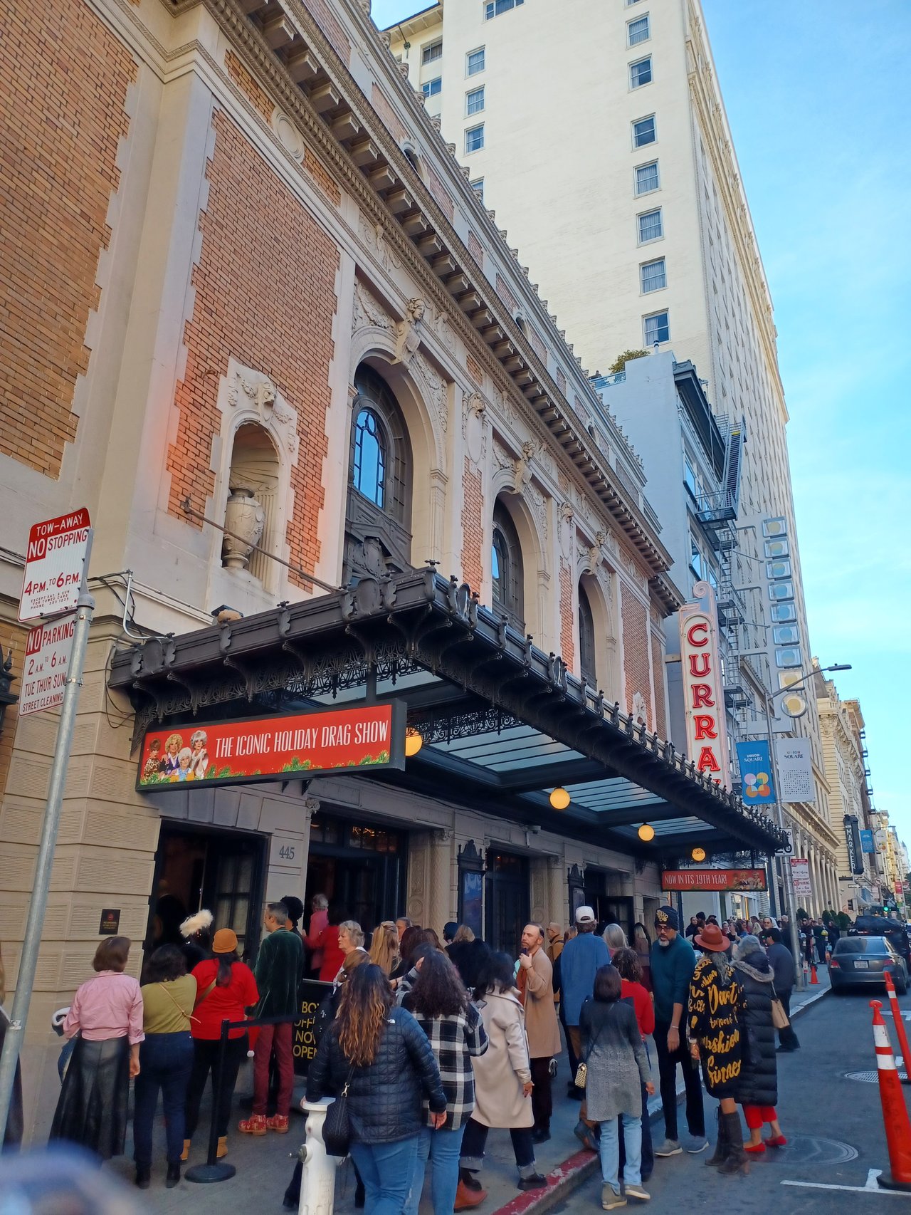 Curran Theatre exterior: Line of people for "THE ICONIC HOLIDAY DRAG SHOW" / "The Golden Girls Live: The Christmas Episodes.