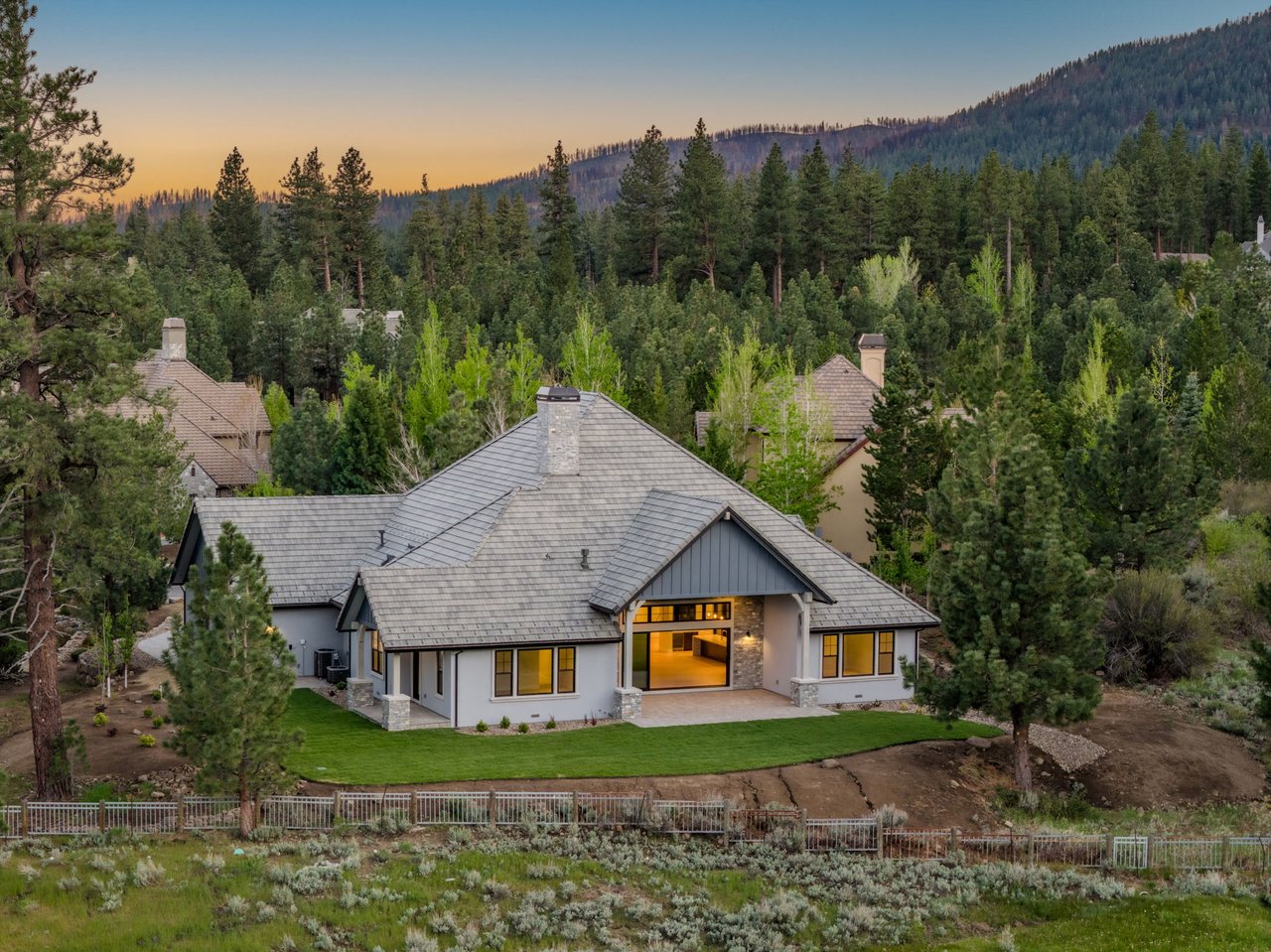 Aerial view of Montreux Golf & Country Club in Reno Nevada, showing custom luxury homes nestled among pine trees along a Jack Nicklaus signature golf course