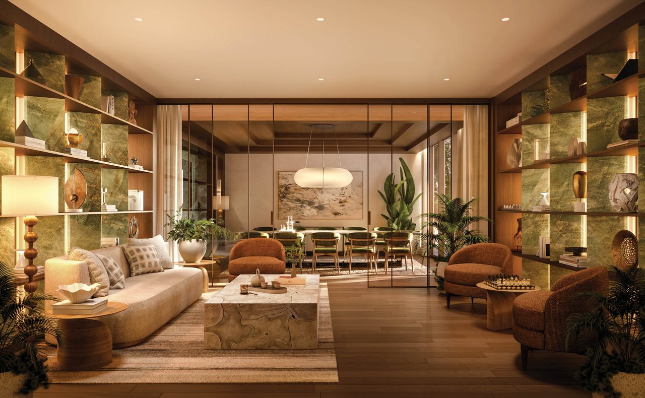 Staged living and dining room with green stone display shelves, a cream sofa, and rounded lounge chairs.