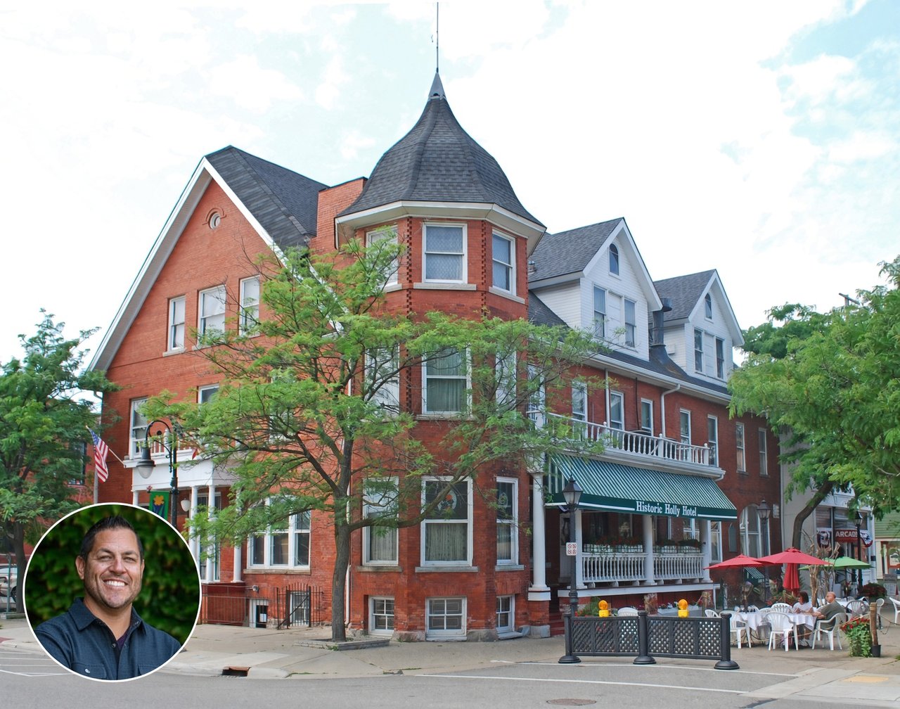 Historic Holly Hotel with a pointed turret, green awning, and outdoor dining patio.
