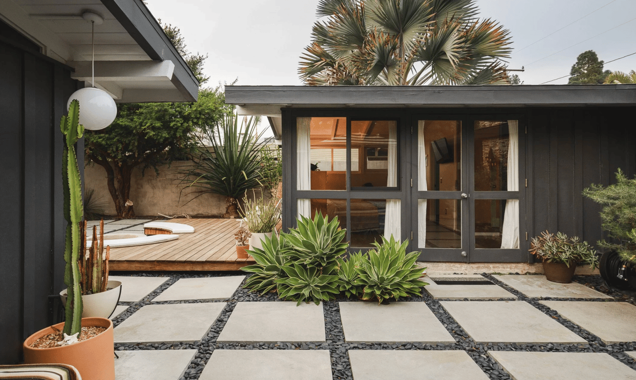 A Rancho Estates house today, its glass wall pulled straight back onto the patio deck, the same indoor-outdoor pairing Cliff May built the whole tract around.