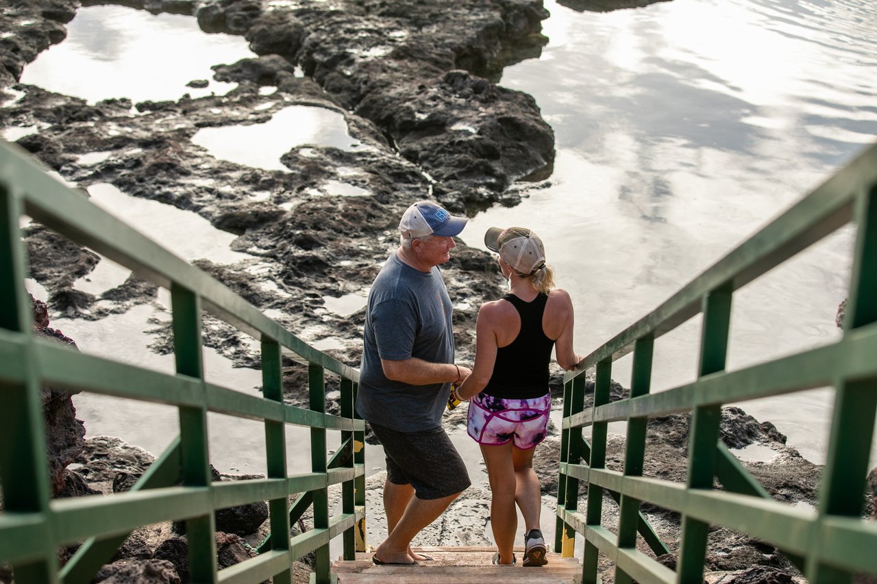 Couple walking down oceanfront stairs on Lāna‘i Hawaii