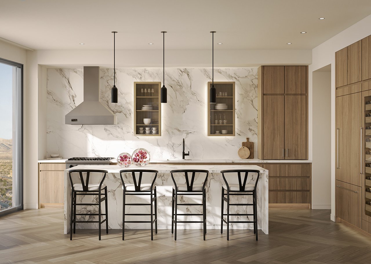 Modern Cello Tower kitchen with a marble island, warm wood cabinetry, and four black barstools.