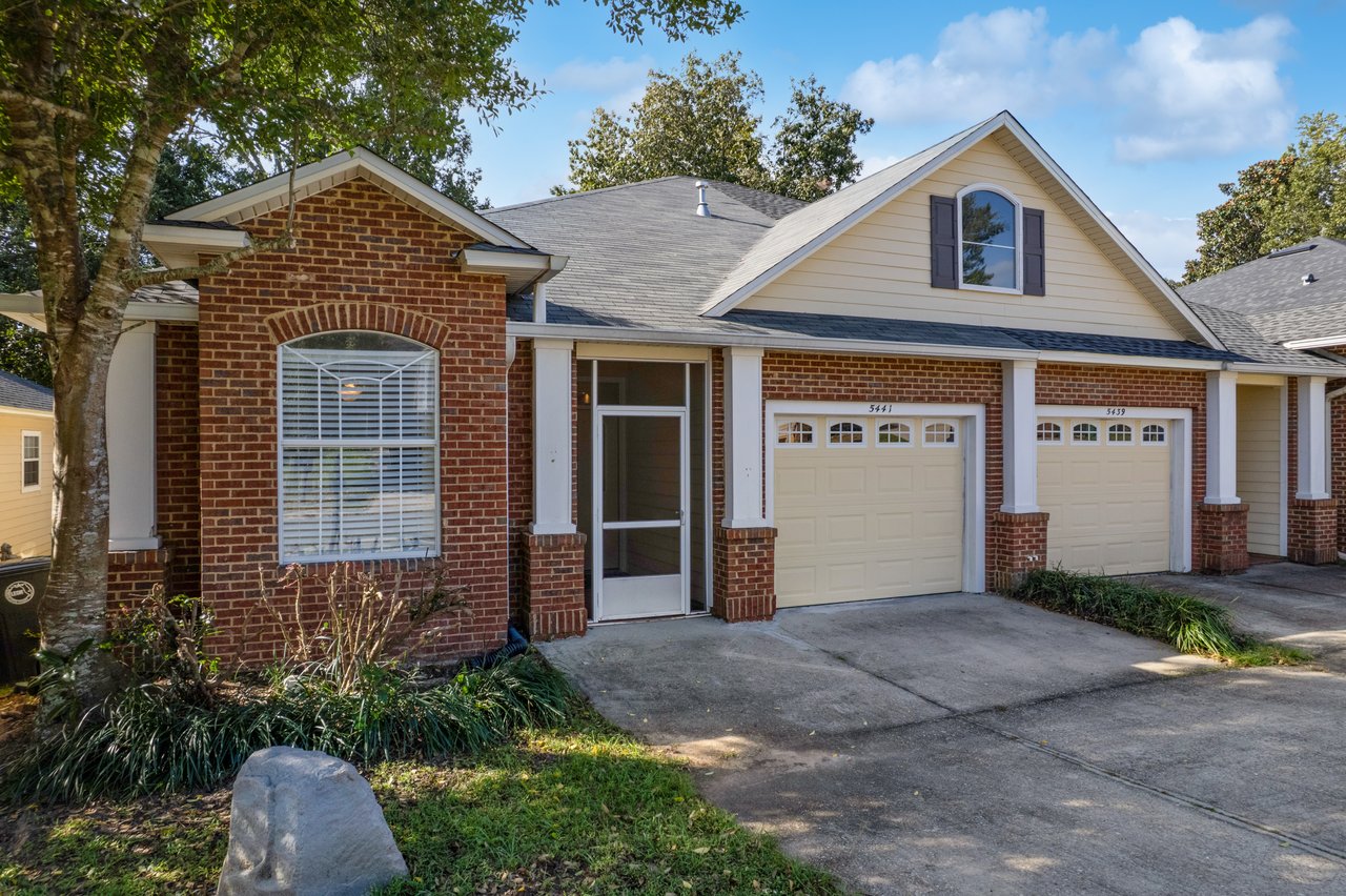 Front exterior of 5441 Hampton Hill Circle, Tallahassee, Florida 32311 showing brick and siding façade, garage, and covered entry.