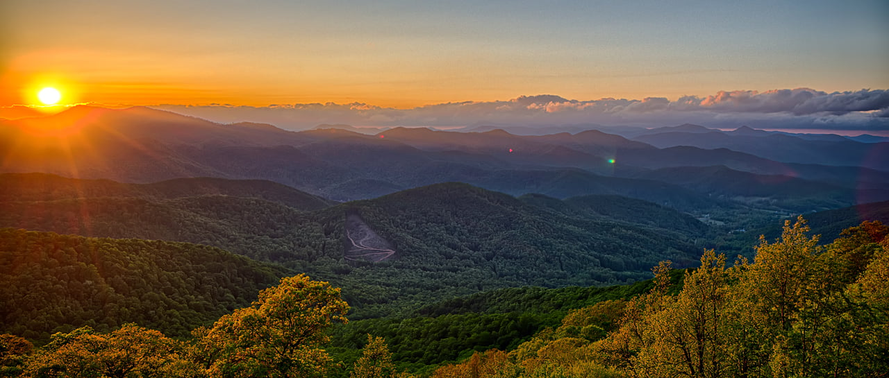 Beautiful sunrise over the mountains Vignette Real Estate