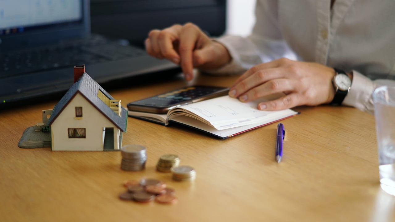 Home buyer calculating monthly mortgage budget and expenses before purchasing a house