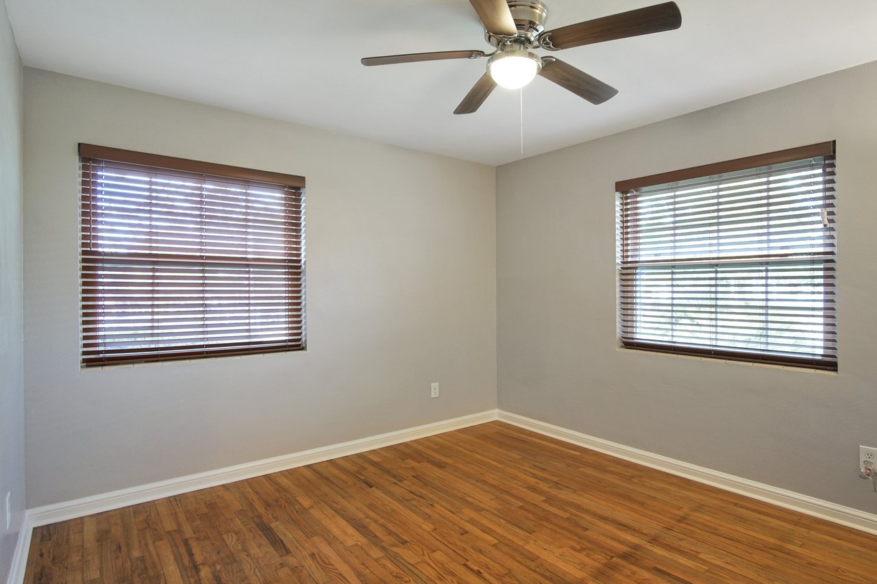 A cozy room featuring hardwood floors and a ceiling fan, creating a warm and inviting atmosphere.