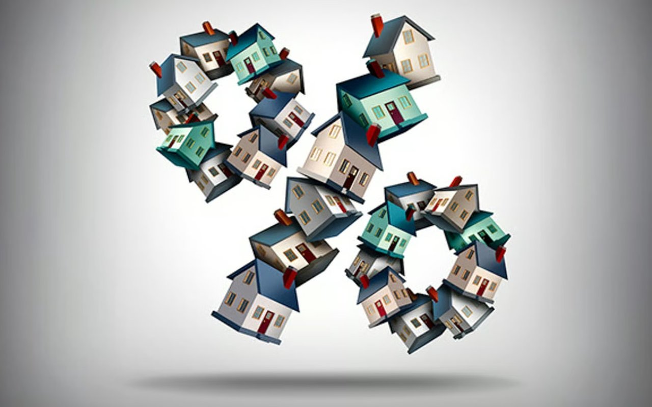Colorful miniature houses float in clustered groups above a soft shadow.
