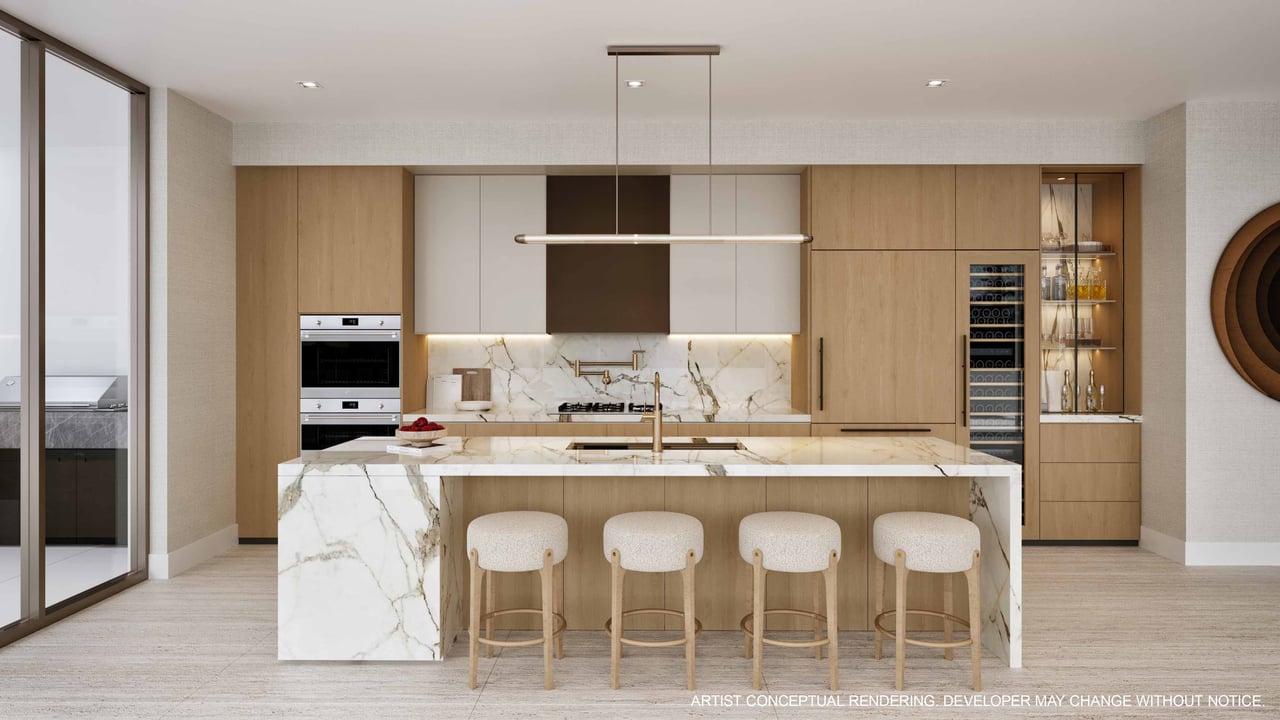Modern kitchen with a marble-veined island, light wood cabinetry, and four upholstered bar stools.