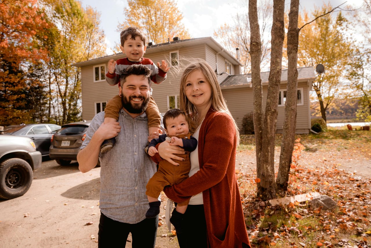 family in front of their new house