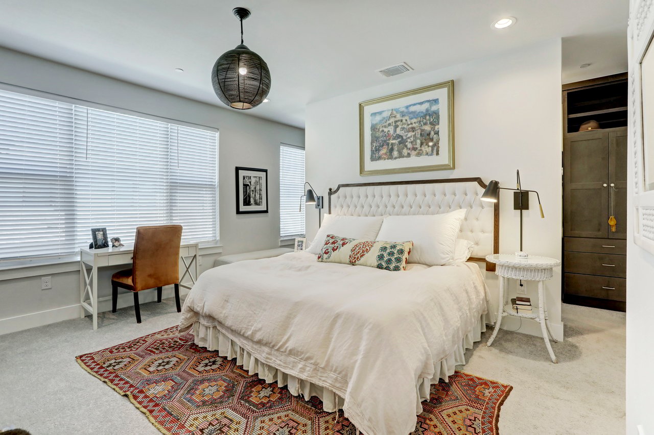 Bedroom at 4709 Unity Circle #273, The Grove, Austin, TX, with an upholstered tufted headboard and a built-in window seat.