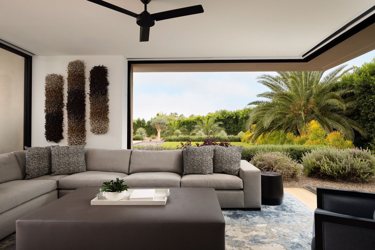 Modern luxury home in Paradise Valley with resort-style backyard, pool, fire feature, and contemporary architecture at sunset.