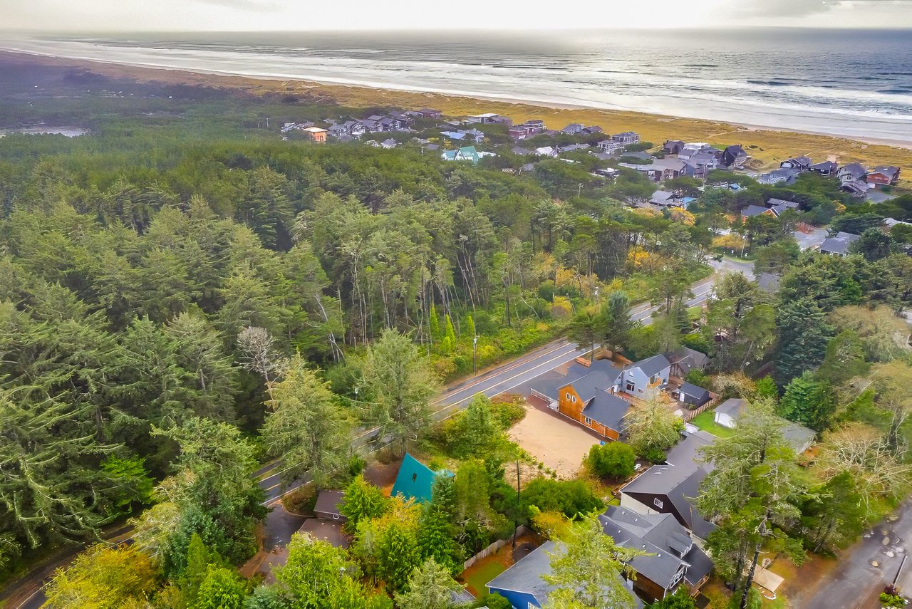 Sold Manzanita land at 00 Sitka with trees, available utilities, R-2 zoning, and a location near the ocean beach.