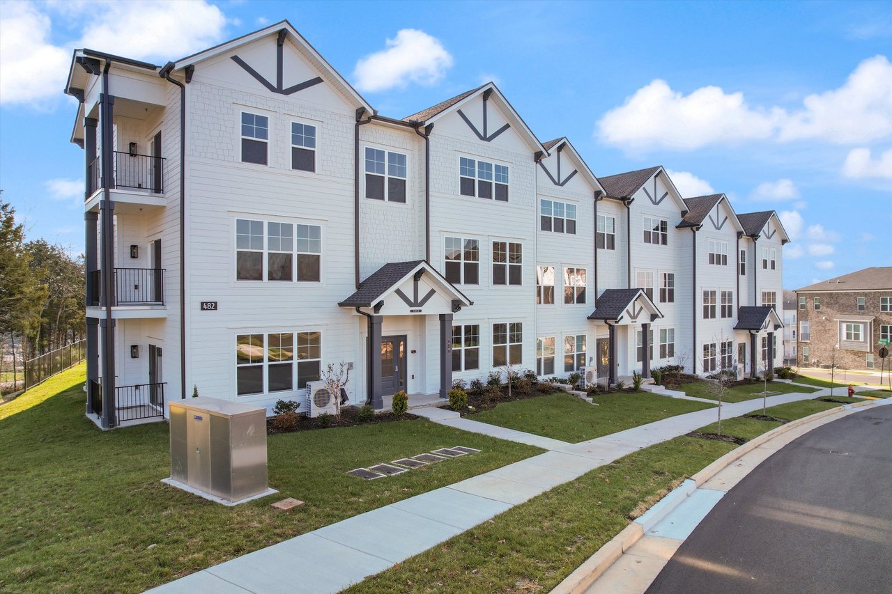 Exterior view of modern new construction condos at 482 Portsdale Drive in Brentwood, Tennessee, showcasing contemporary architecture, landscaped grounds, and affordable move-in-ready homes near Nashville.