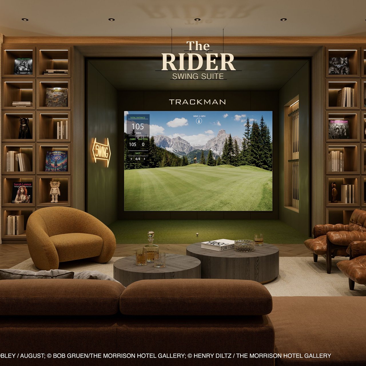 Furnished golf simulator lounge with a Trackman screen, illuminated shelving, and leather seating.