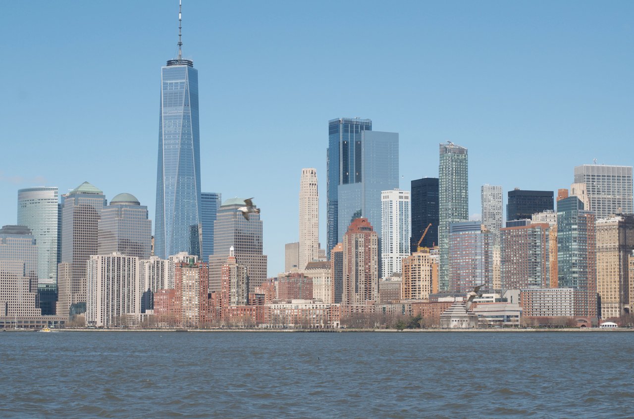Historic commercial buildings and modern office towers along Water Street in Manhattan's Financial District.