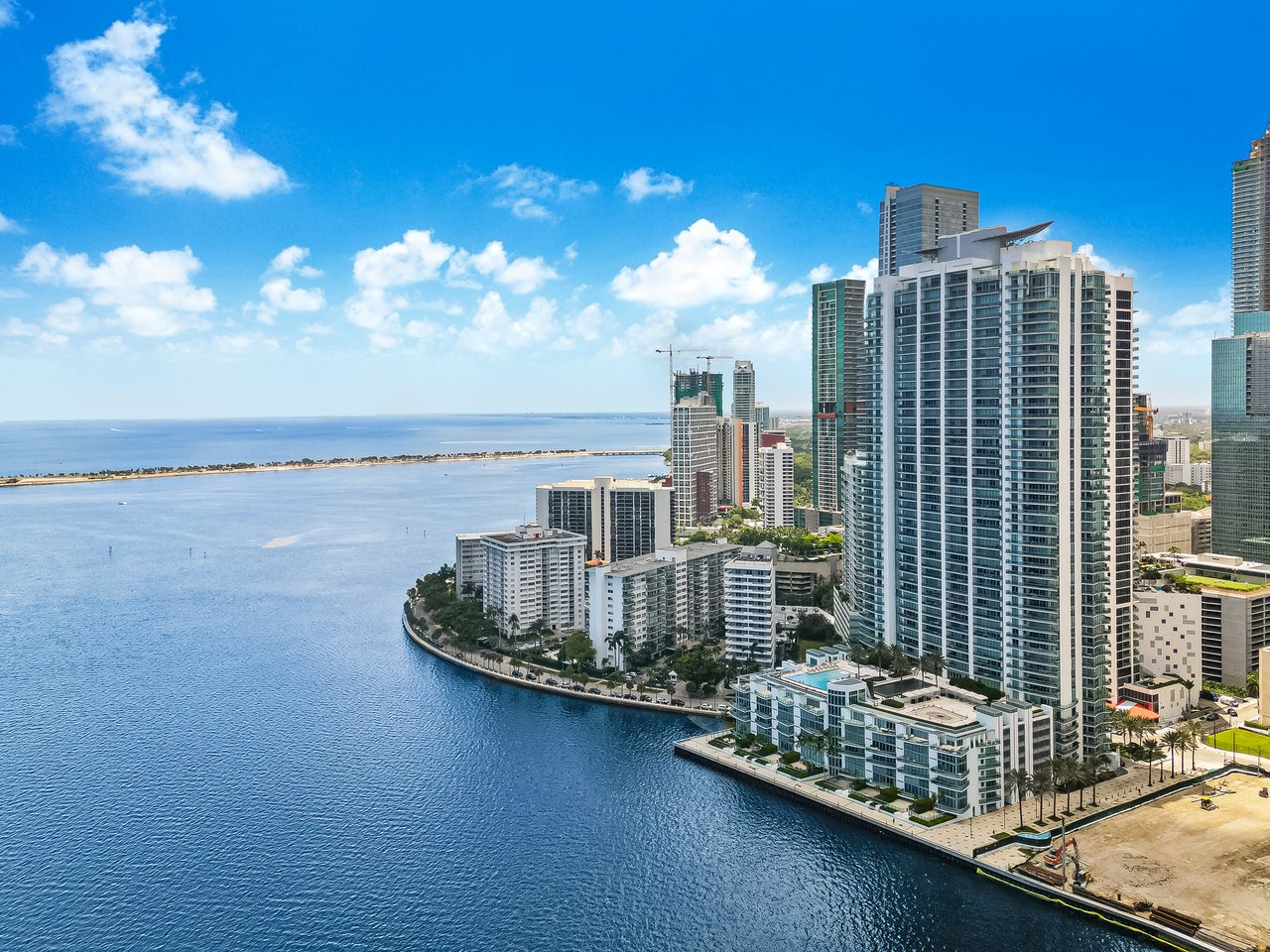 Aerial view of Jade Residences along Biscayne Bay with the Brickell waterfront and Miami skyline