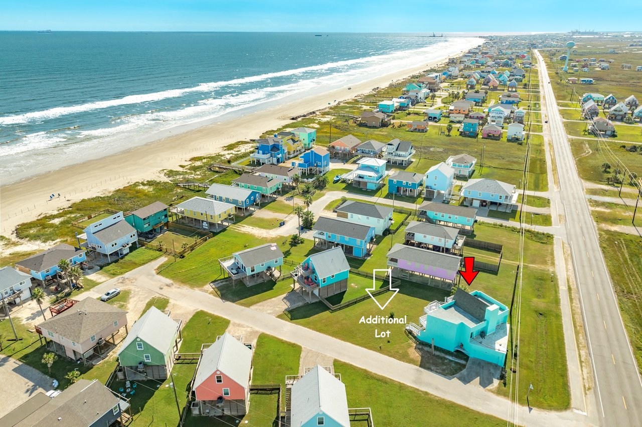 Aerial view of blue gulf coast, with sandy beaches and the turquoise 131 Jean Lafitte home presented by Carter Signature Properties
