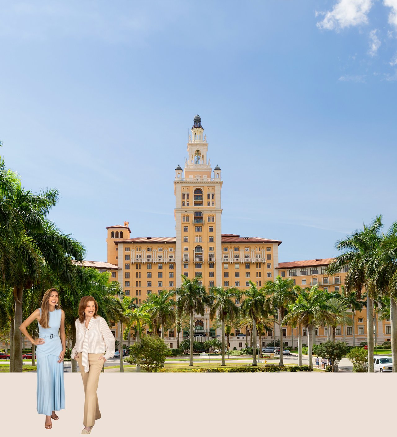 The Biltmore Hotel in Coral Gables behind two women, framed by palm trees.