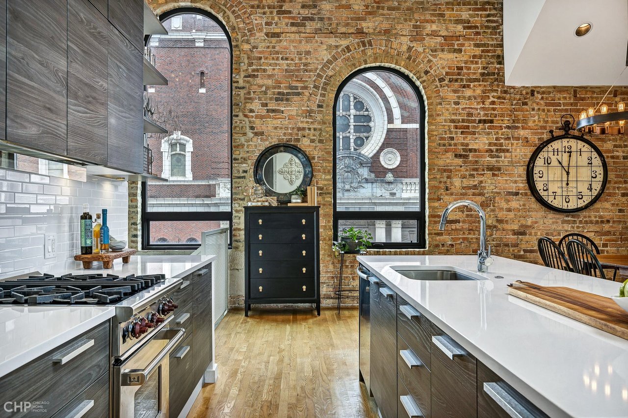 Loft with dark wood kitchen and view of church