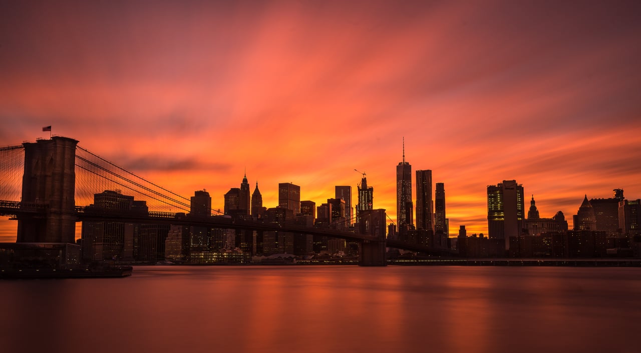 The Clock Tower condominium at 1 Main Street in DUMBO, Brooklyn, featuring historic loft residences overlooking Brooklyn Bridge Park, the East River, and the Manhattan skyline.