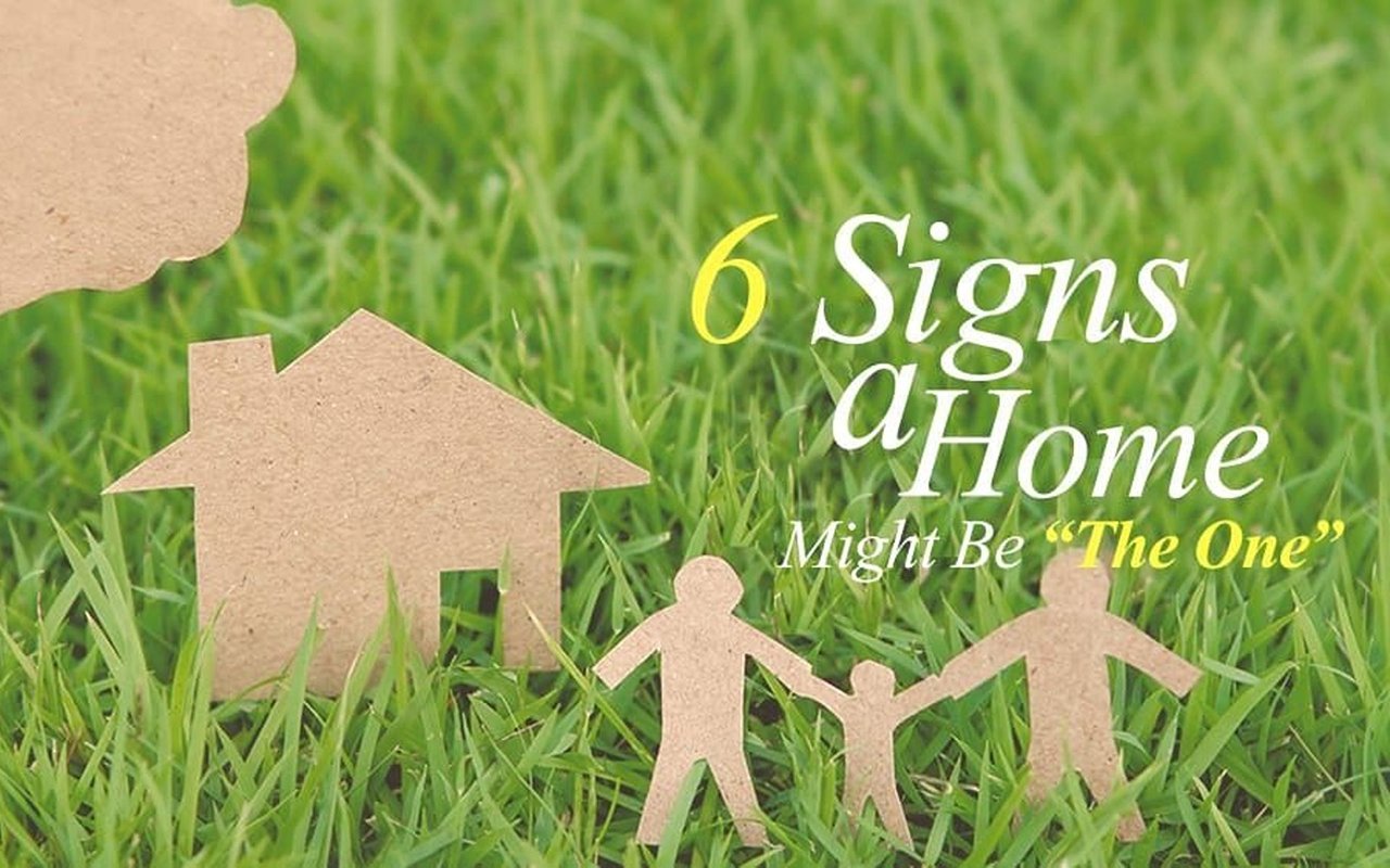 6 signs a home might be “the one,” illustrated with a cardboard house and family in grass.