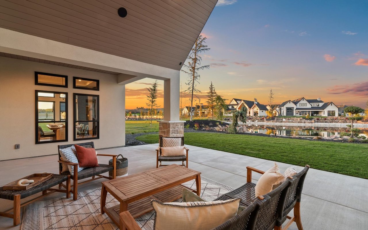 Covered back patio with teak and black wicker furniture