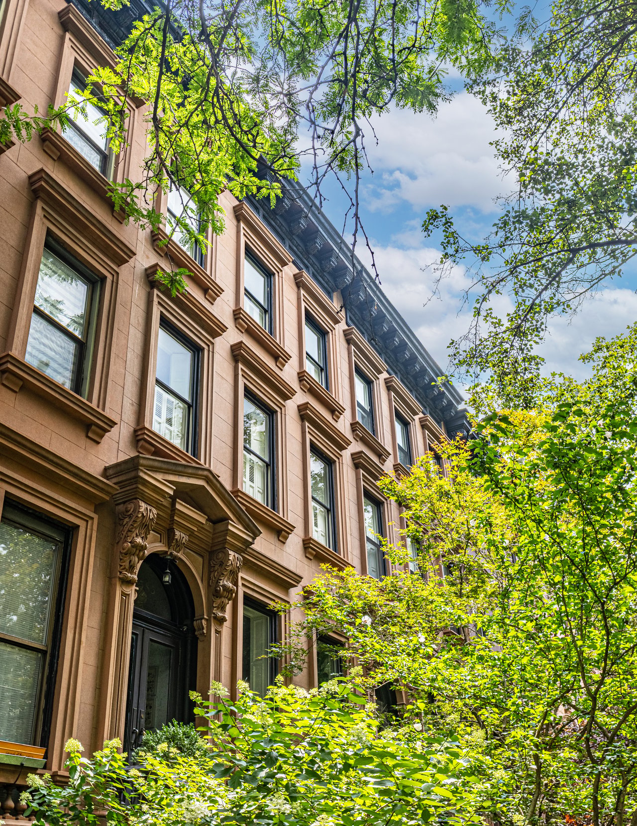 Historic brownstones, townhouses, and multifamily homes along Monroe Street in Bedford-Stuyvesant, Brooklyn.