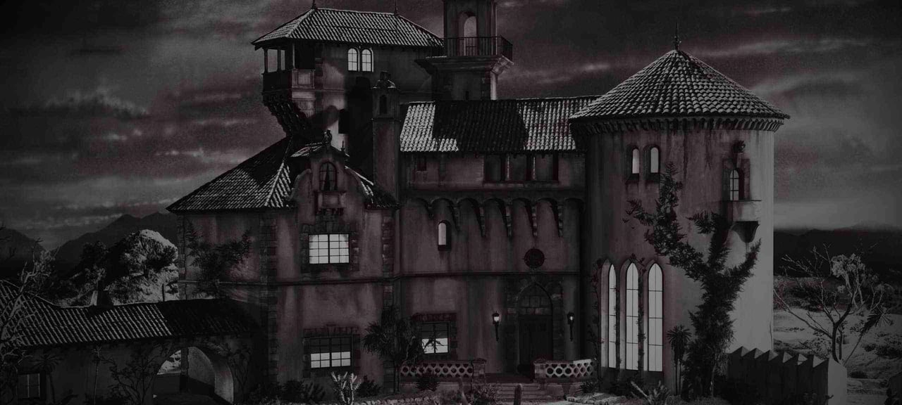 Castle-like stone residence with multiple towers and tiled roofs beneath a dark sky.