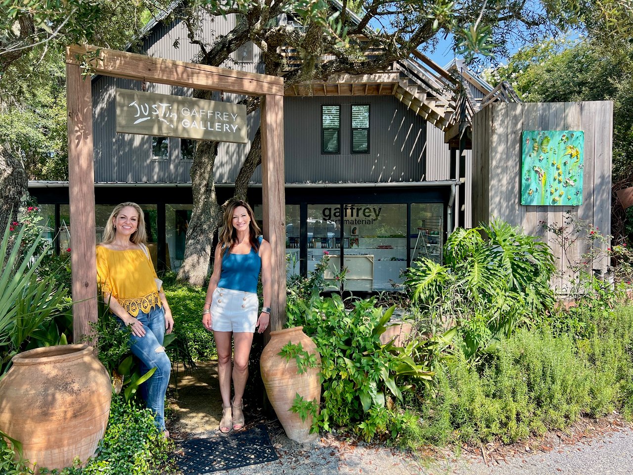 Photo of Kendall standing confidently in front of Justin Gaffrey Gallery, showcasing the vibrant artistic atmosphere of Santa Rosa Beach