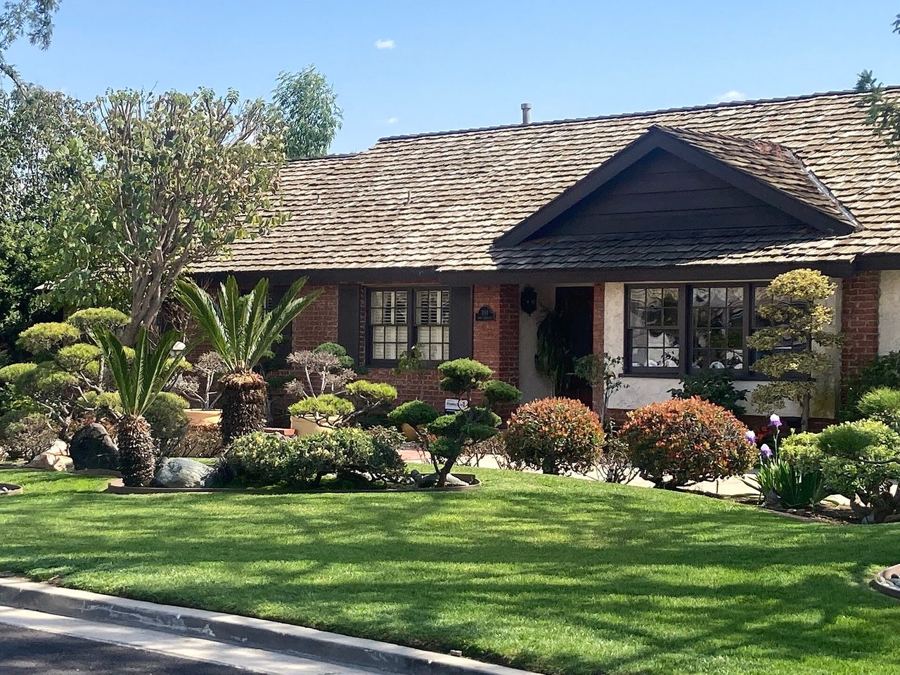Established detached home with mature landscaping in Arcadia, photographed March 2023