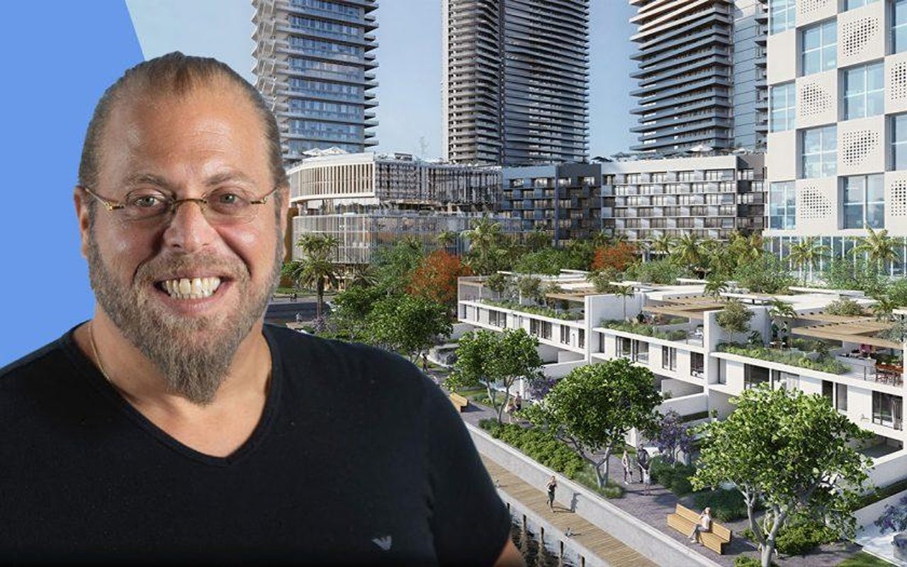 Rendering of a landscaped residential development with high-rise towers, with a smiling man in the foreground