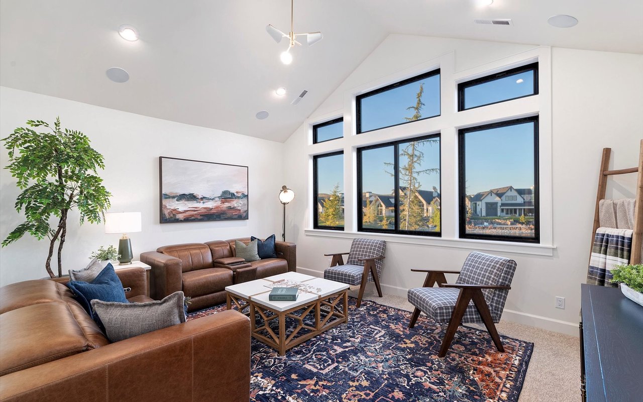 Upstairs bonus or rec room with vaulted ceilings, and large windows overlooking the lake