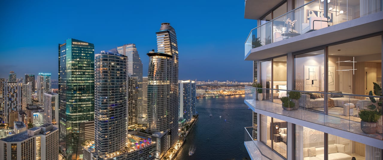 Viceroy Brickell residences overlook Miami’s illuminated skyline and waterfront from glass balconies.