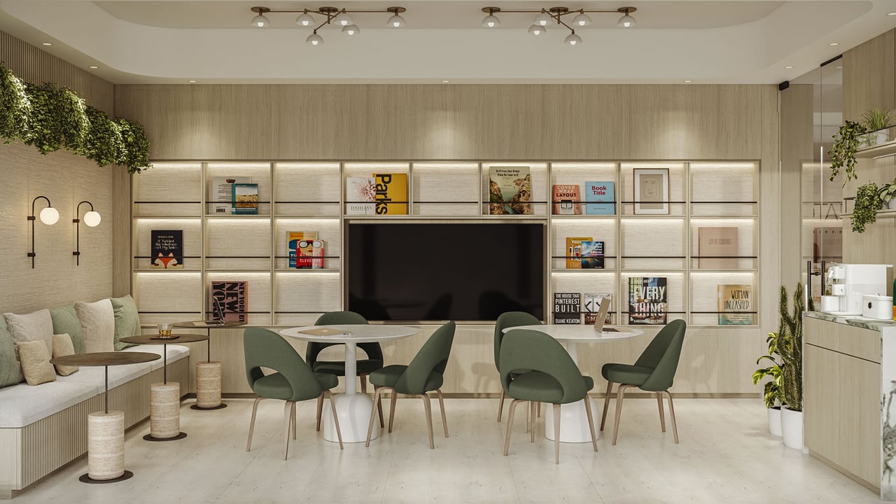 Botanic Residences lounge with illuminated bookshelves, green chairs, bench seating, and a kitchenette.