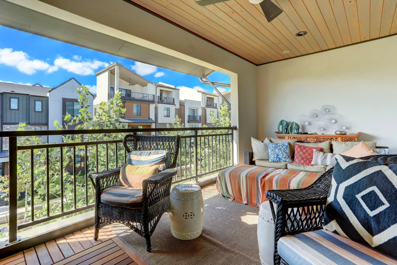 Covered outdoor patio on the third floor of The Grove townhome, Unity Circle, Austin, TX, with a wood-paneled ceiling and outdoor seating overlooking the community.