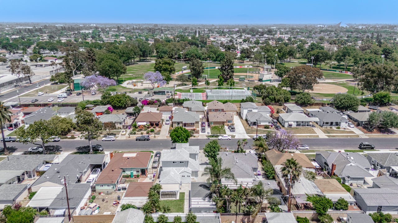 Aerial view of a Long Beach neighborhood and park showing homes, green space, and nearby coastal surroundings
