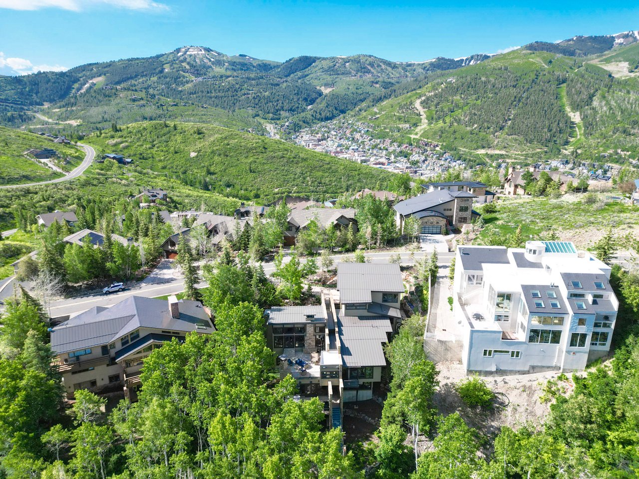 Aerial of homes in the Aerie neighborhood looking down on Old Town Park City and Park City Mountain