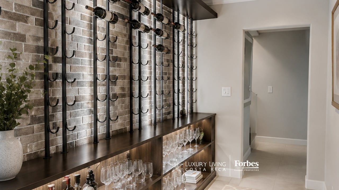 Built-in wine bar with black bottle racks, a dark wood counter, and shelves of glassware.