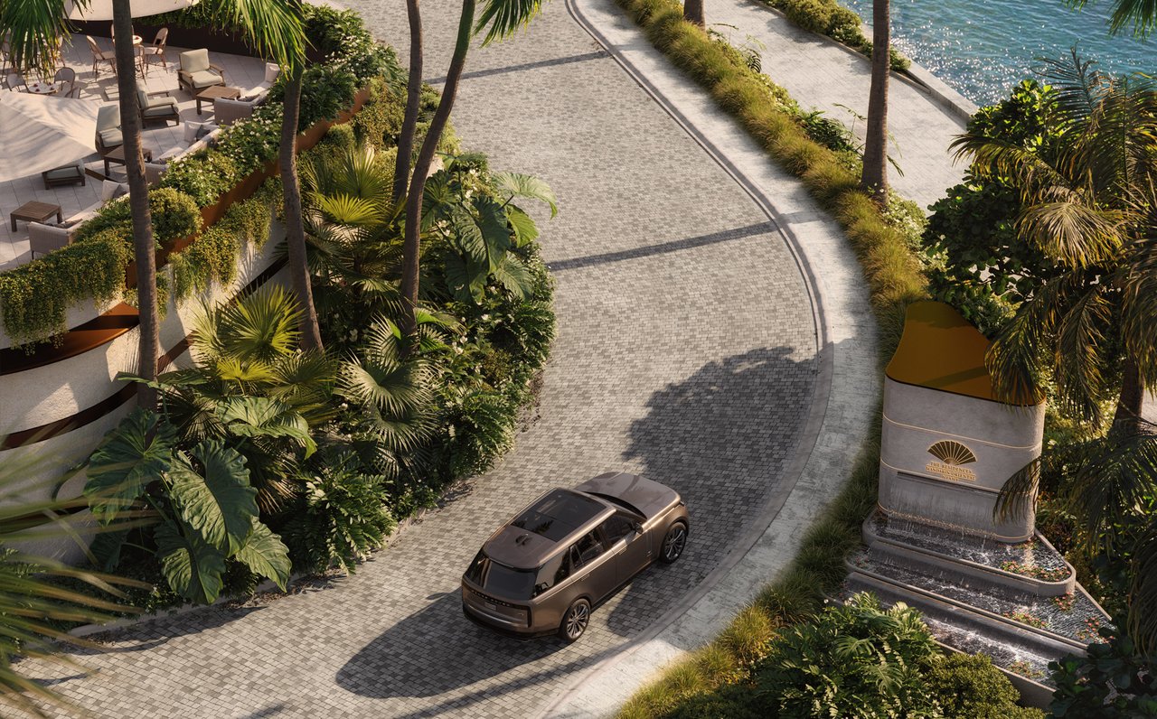 Curving cobblestone entrance drive with tropical landscaping and a Mandarin Oriental residence sign