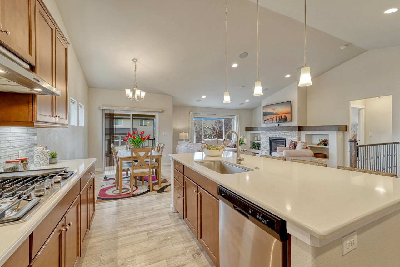 Kitchen island with sink and dishwasher, open to the dining area and living room
