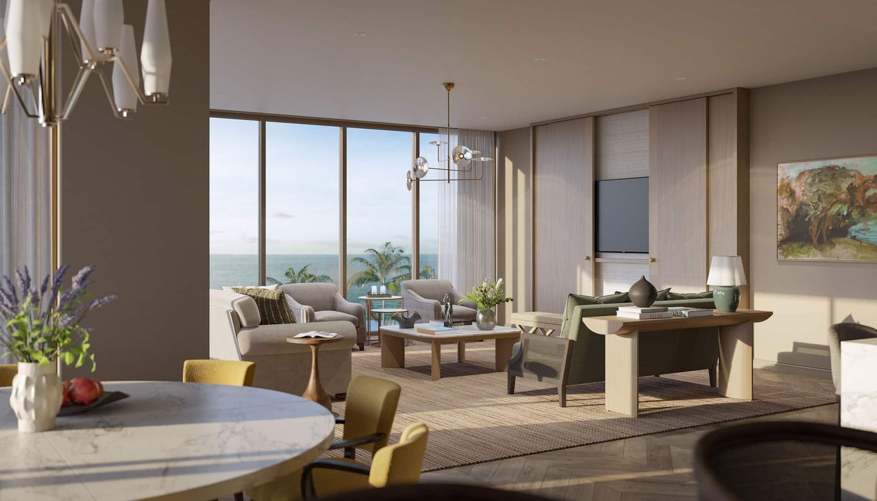 Furnished coastal living room with floor-to-ceiling windows overlooking the ocean.