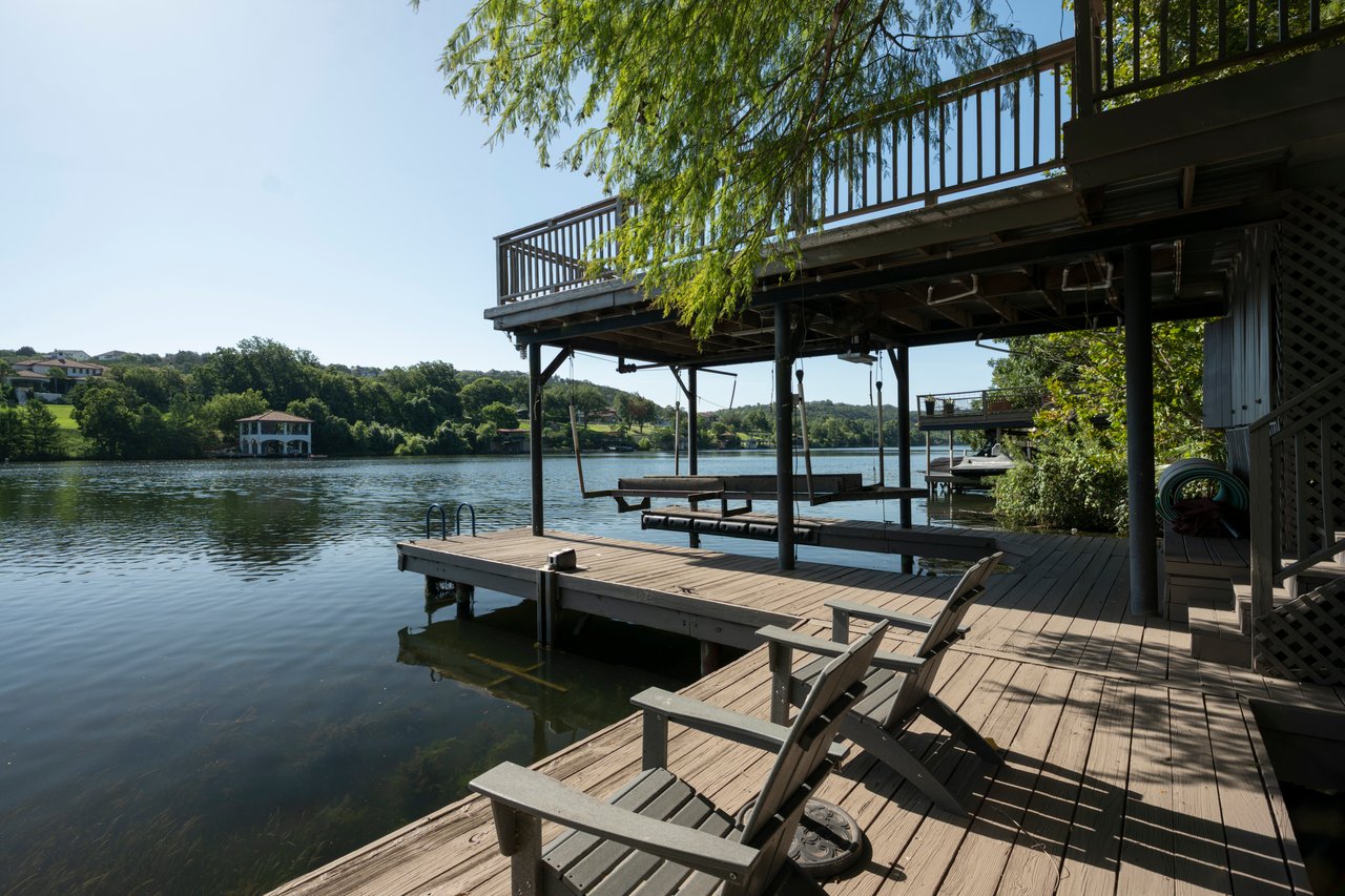 Lake Austin waterfront boat dock with an upper sun deck and Adirondack seating at 2403 Big Horn Drive, Austin.