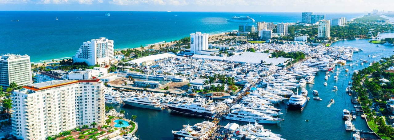 Aerial view of Fort Lauderdale, Florida with marinas, yachts, beachfront hotels, and the Atlantic Ocean.
