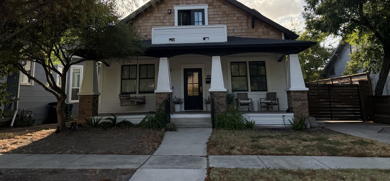 Bungalow with a covered porch, brick column bases, and a shingled upper gable.